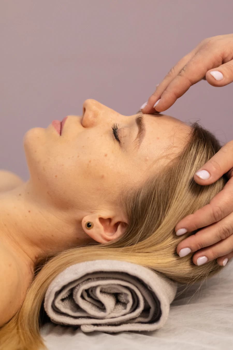 Therapist performing a relaxing head and facial massage