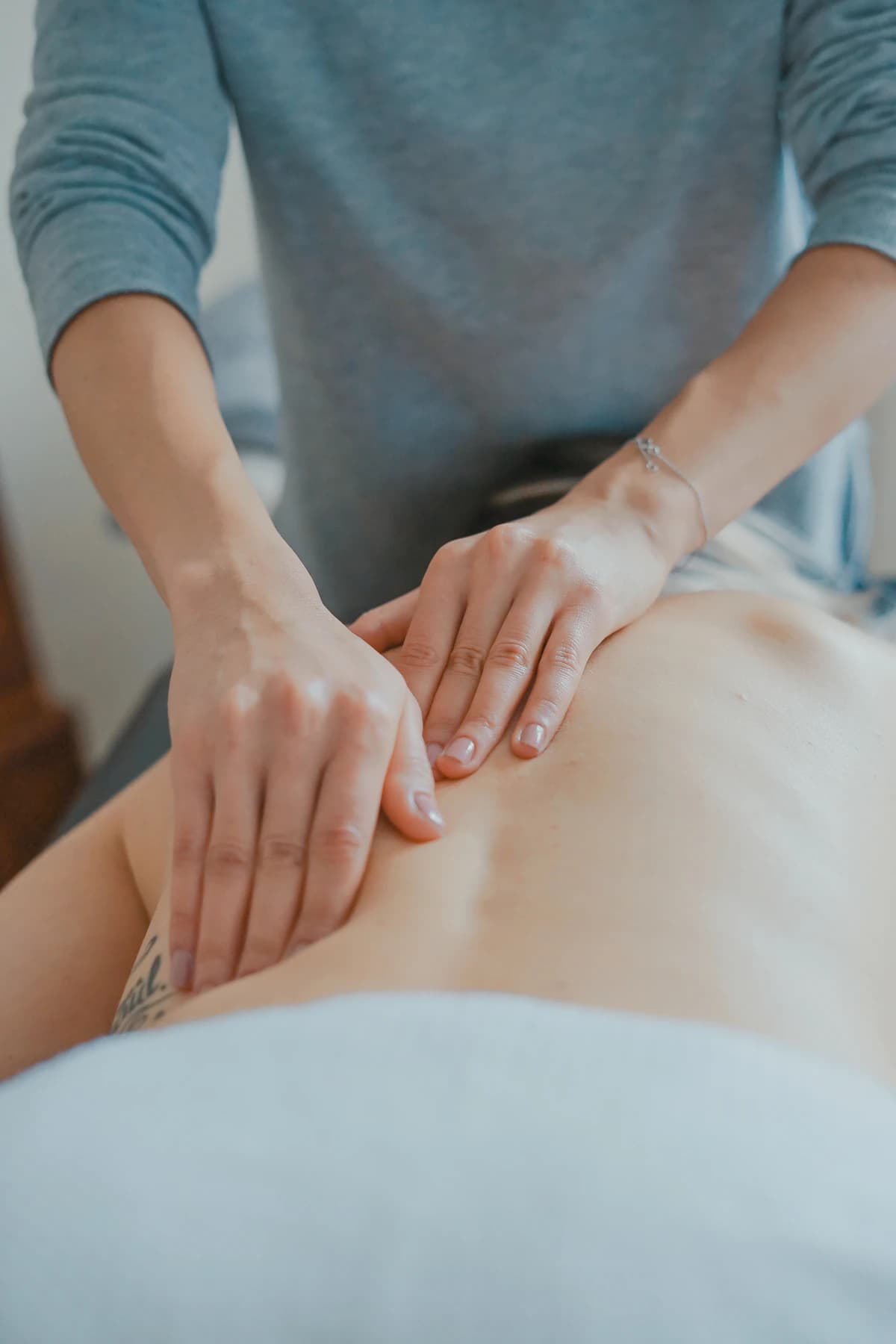 Professional therapist giving a relaxing back massage