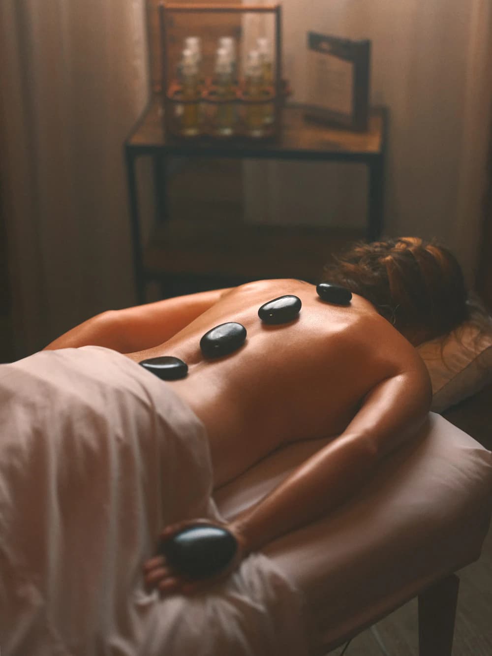 Hot stone massage therapy in a spa setting