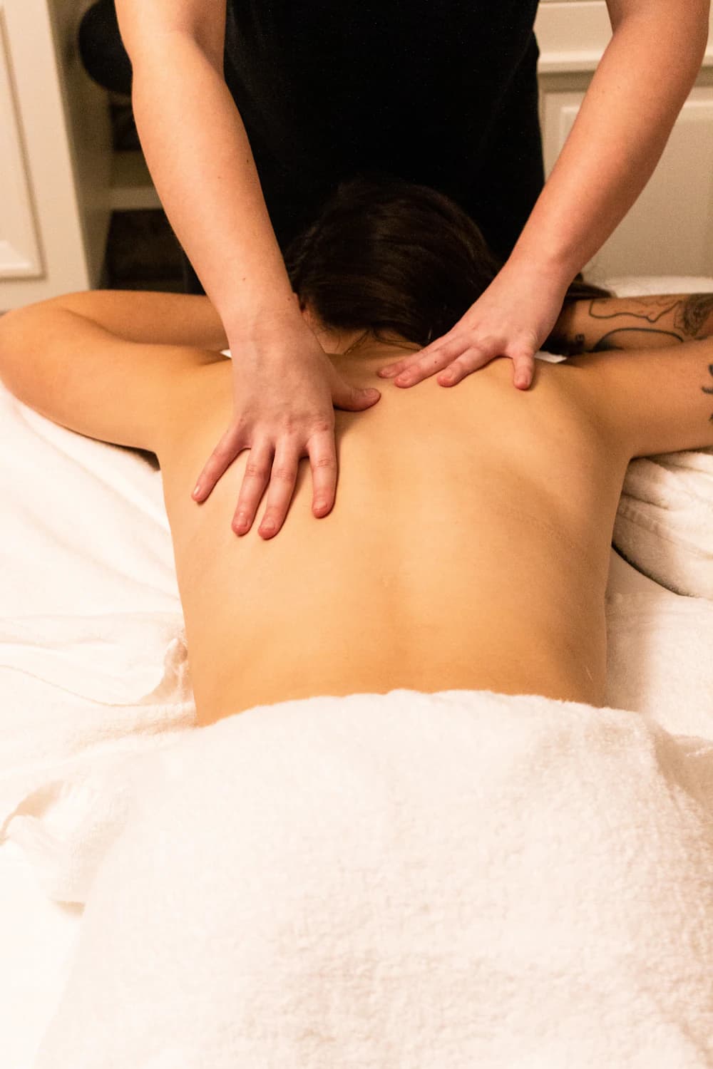 Therapist performing a shoulder and neck massage
