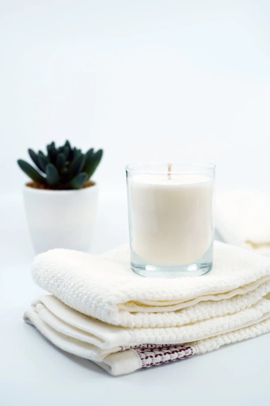 Fresh towels and a candle arranged for a spa session